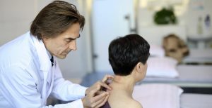 Succesvolle acupuncturist in Assen voert behandeling uit met dunne naalden op specifieke punten van patiënt